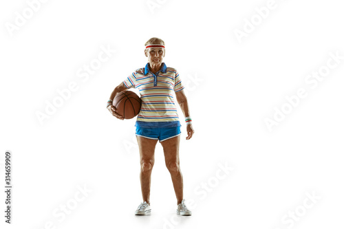 Move. Senior woman wearing sportwear playing basketball on white background. Caucasian female model in great shape stays active. Concept of sport, activity, movement, wellbeing, confidence. Copyspace. © master1305