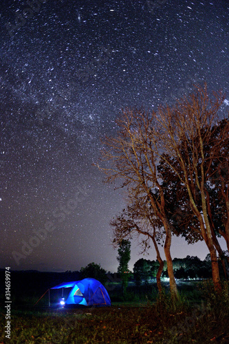 Blue tent and stars in forest