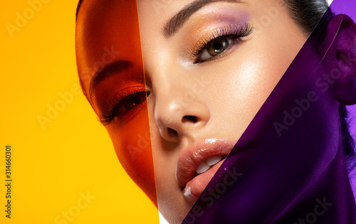Beautiful white girl with bright eye-makeup. Beautiful fashion woman with  a colored  items.   Glamour fashion model with bright gloss make-up posing at studio. Stylish fashionable concept. Art.
