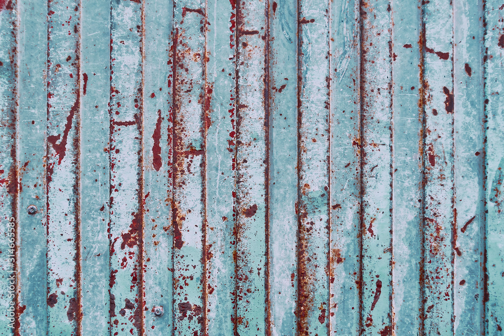 detail of stripped metal garage or store door texture; metal background detail of stripped metal garage or store door texture; metal background