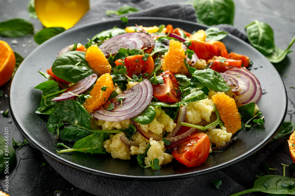 Vegetable Millet salad with red onion, cherry tomatoes, spinach, tangerine and clementine dressing. healthy food Vegetable Millet salad with red onion, cherry tomatoes, spinach, tangerine and clementine dressing. healthy food