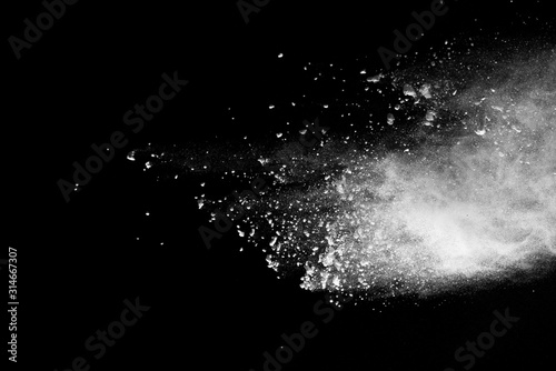 White powder explosion isolated on black background.