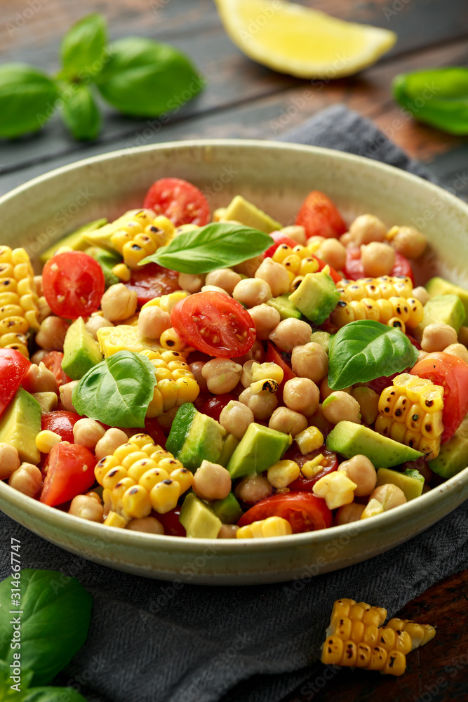 Avocado chickpea salad with grilled sweet corn, tomato and basil. Healthy vegan food Avocado chickpea salad with grilled sweet corn, tomato and basil. Healthy vegan food