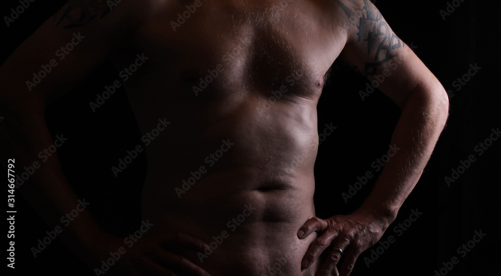 A naked middle aged man with hands on hips A naked middle aged man with hands on hips