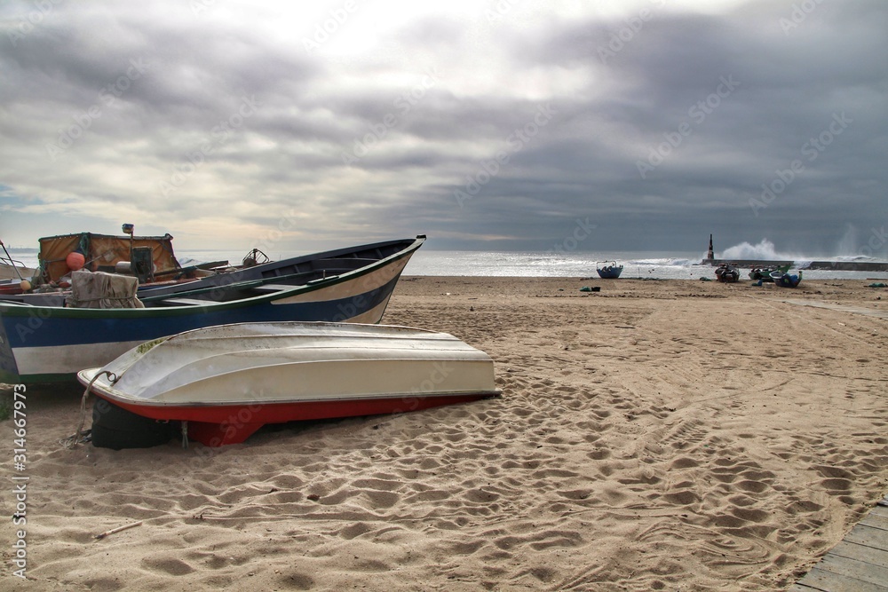 Fishing boats stranded on Aguda beach and Giant waves breaking on the breakwater