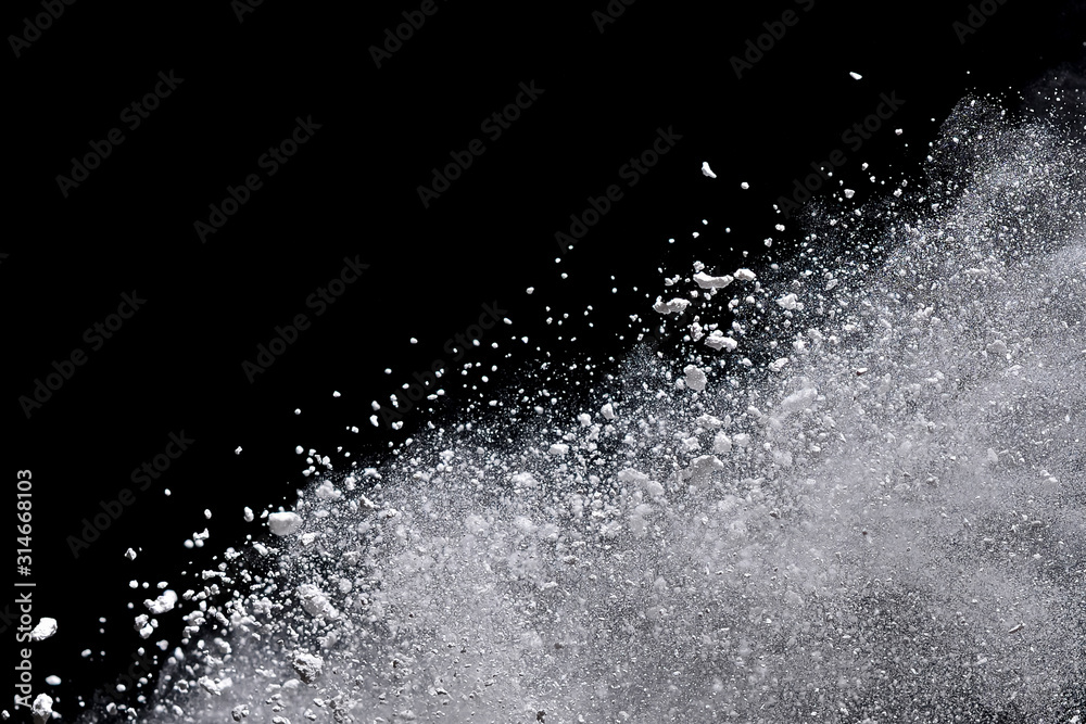 White powder explosion isolated on black background.