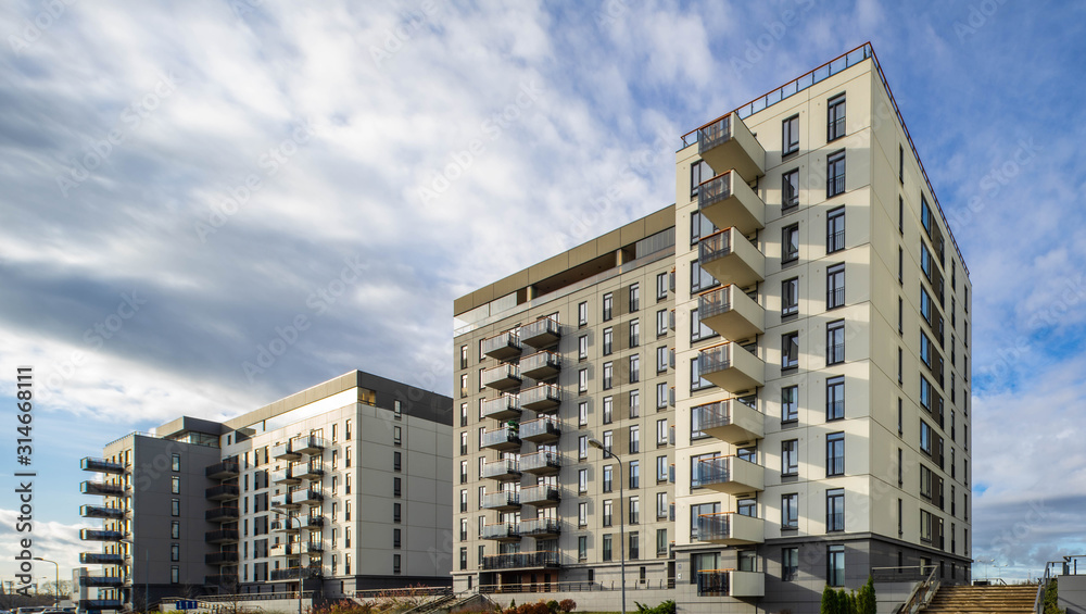 View of a modern residential multi-storey building. Cloudy sky. View of a modern residential multi-storey building. Cloudy sky.