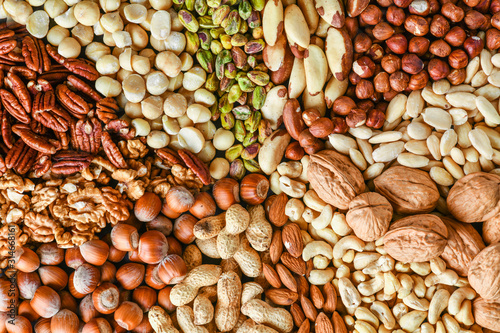 Natural healthy background made from different kinds of mix nuts like walnuts, hazelnut, pistachio, almond, cashew, pecans.