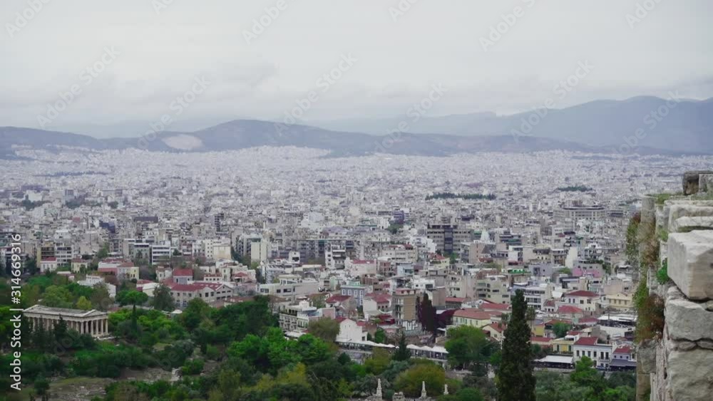Panning view of Temple of Hephaestus from hill with overlook of Athens city in Greece Panning view of Temple of Hephaestus from hill with overlook of Athens city in Greece