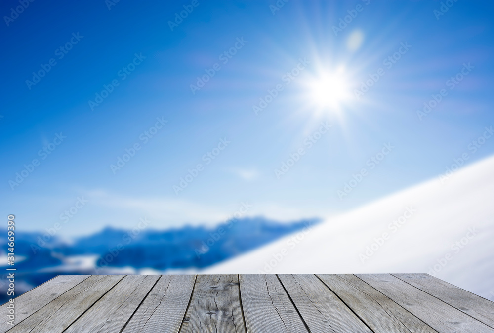 wood display shelf winter table top against snow mountain panorama blue sky