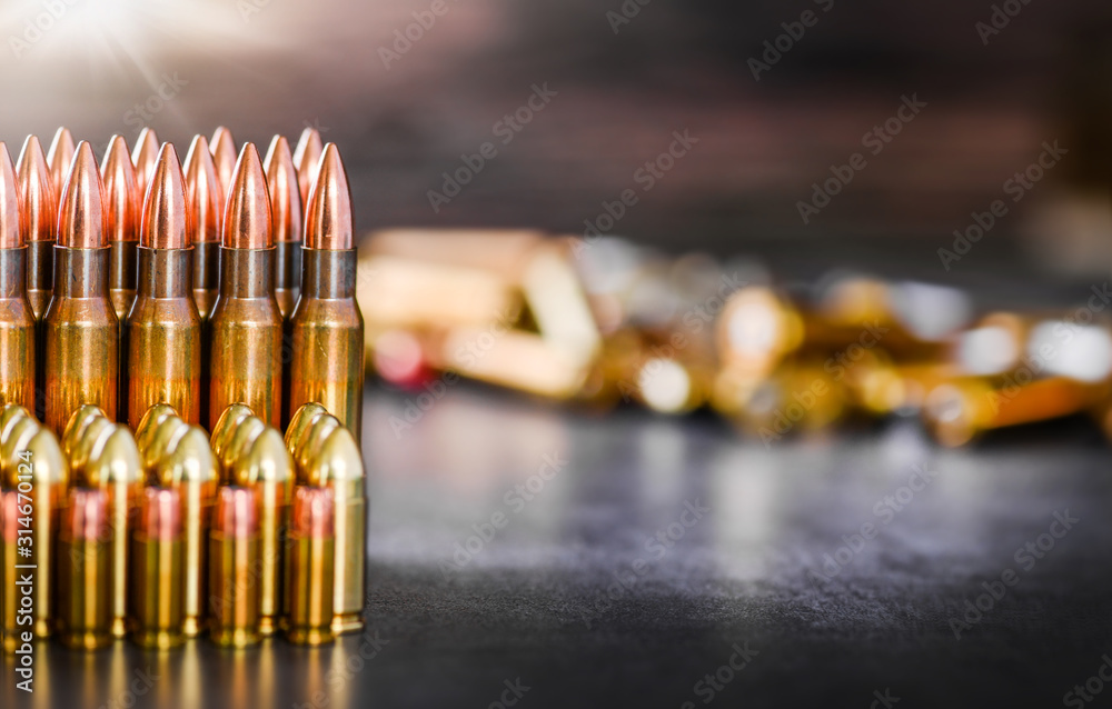Various kind of bullets or ammonution on dark stone table. Bullet pile ...