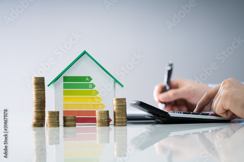 Man Calculating Energy Efficient House