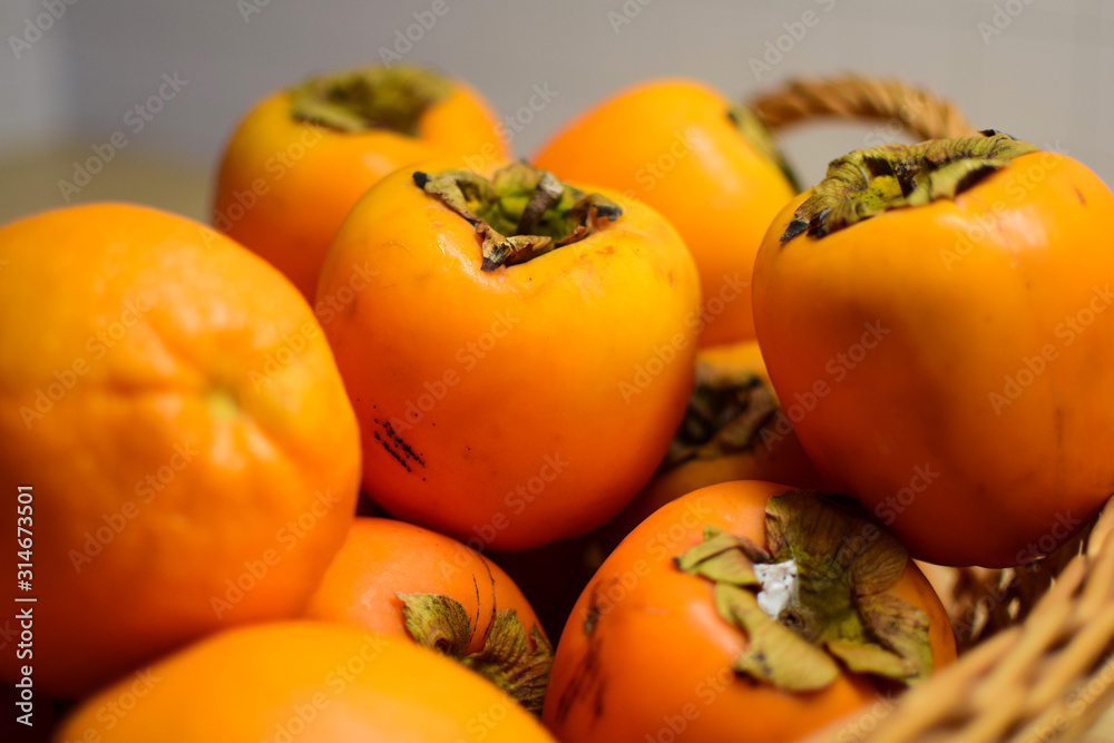 Orange fruits close-up. Oranges, tangerines and persimmons. Orange fruits close-up. Oranges, tangerines and persimmons.