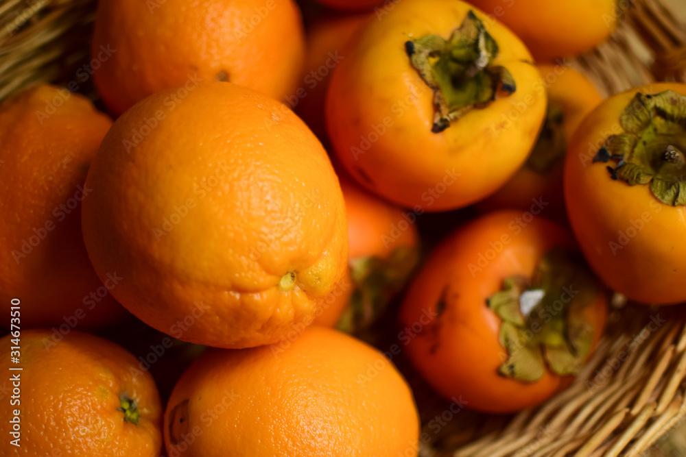 Orange fruits close-up. Oranges, tangerines and persimmons. Orange fruits close-up. Oranges, tangerines and persimmons.