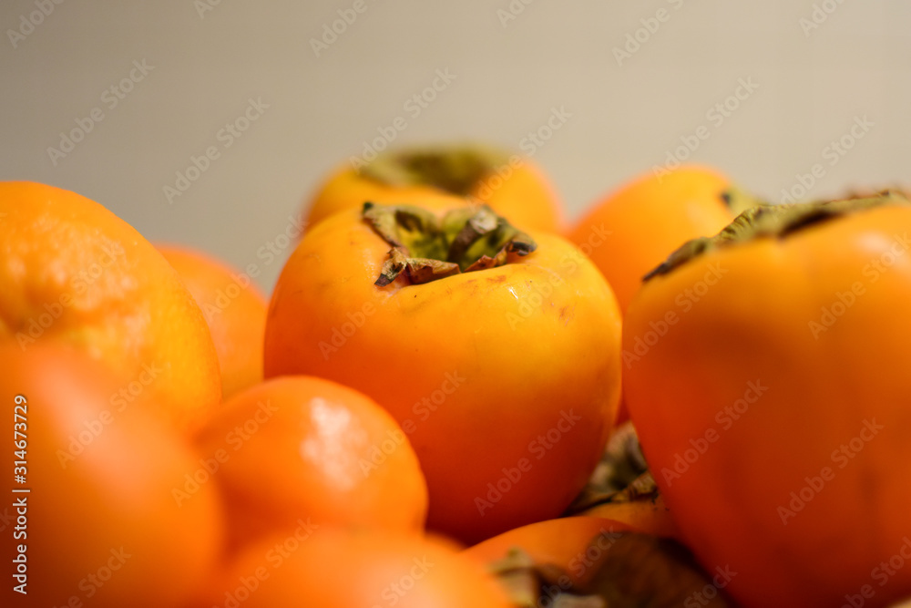 Orange fruits close-up. Oranges, tangerines and persimmons. Orange fruits close-up. Oranges, tangerines and persimmons.