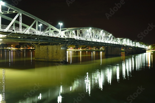 bridge cross river and reflection light bulb on night in Vietnam