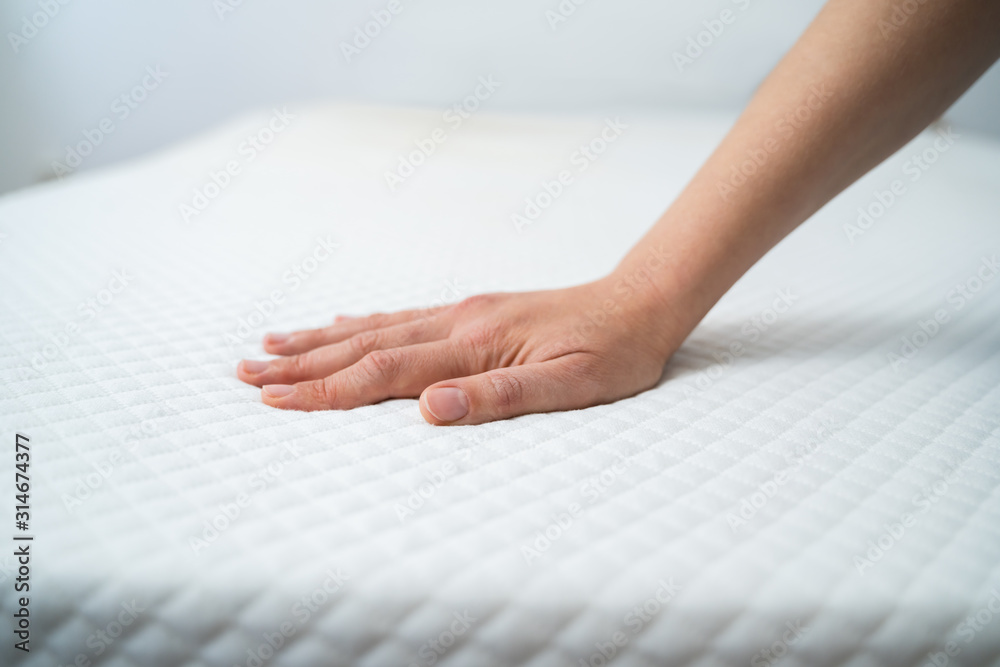 © Andrey Popov - Hand Testing Mattress © Andrey Popov - Hand Testing Mattress