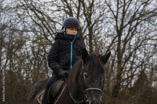 Fun boy riding a horse on holiday © Normunds