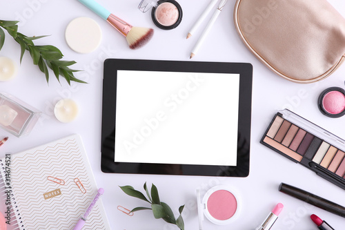 cosmetics and modern tablet on a colored background top view. Beauty blog concept.