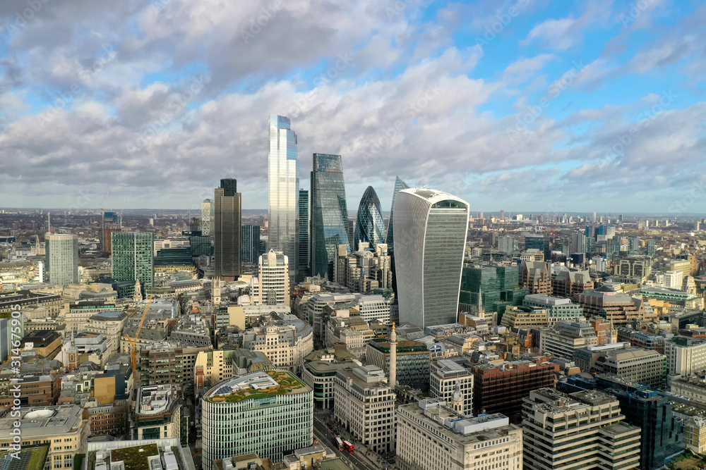 London city centre aerial panorama view: financial district, Thames river, Belfast, skyscrappers, warf and buildings and St. Pauls Cathedral, Tower Bridge and The Tower