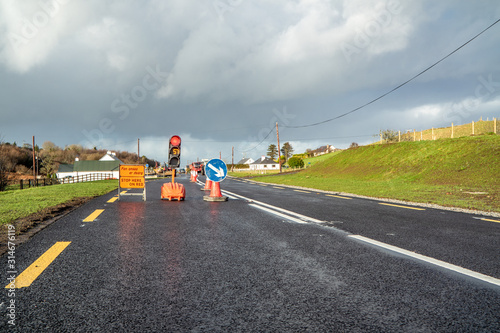 Traffic light counting down at road construction site photo