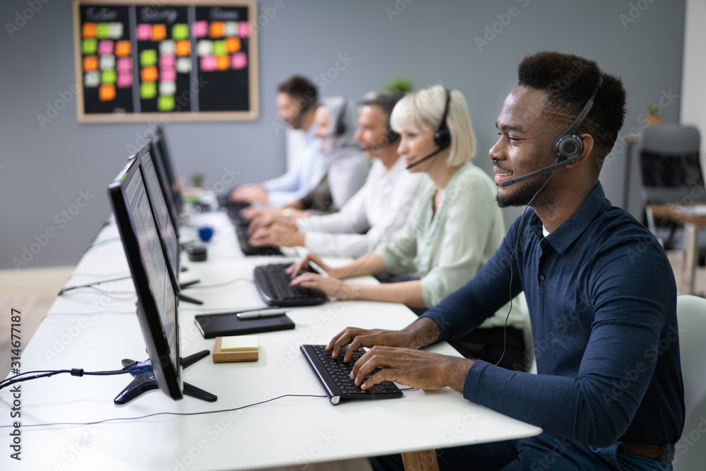 Male Customer Services Agent In Call Center - obrazy, fototapety, plakaty 