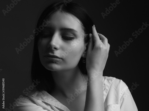 Black and white portrait of young beautiful lady. Studio