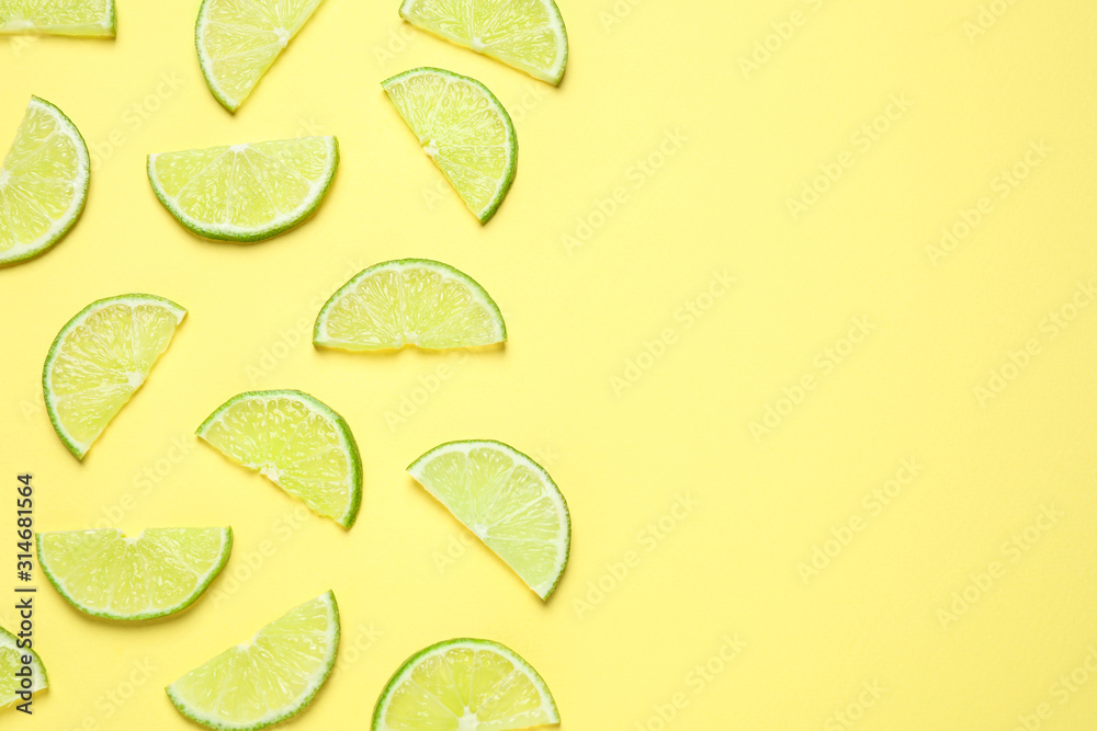 Juicy fresh lime slices on yellow background, flat lay. Space for text Juicy fresh lime slices on yellow background, flat lay. Space for text