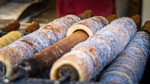 Trdelnik - traditional national czech street desert, baking on the street of Prague.