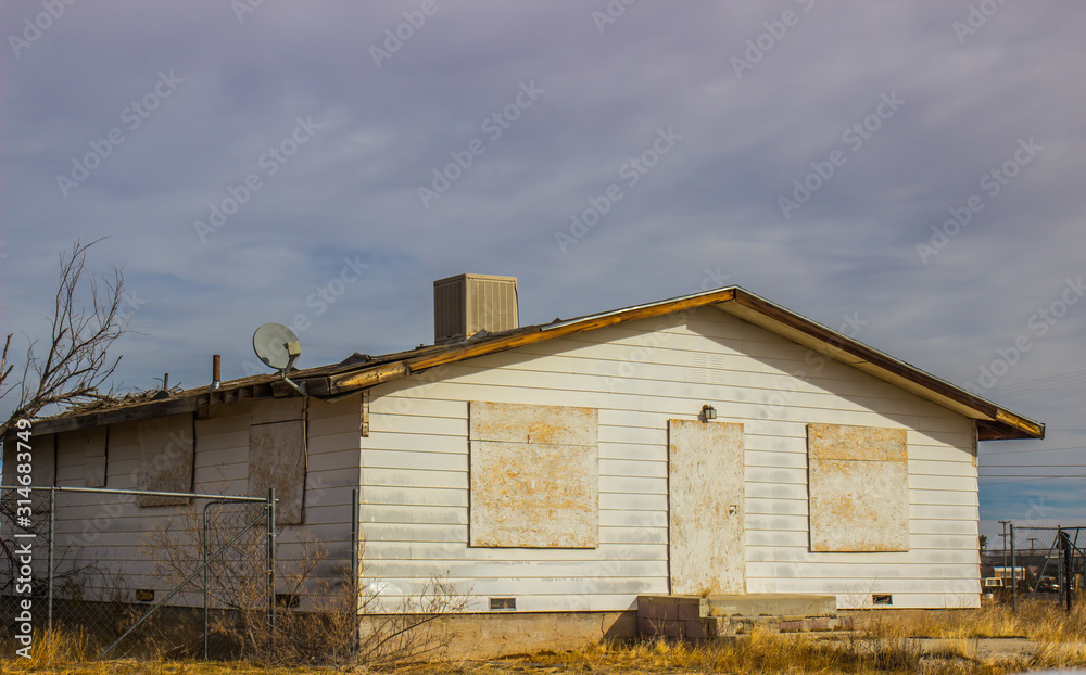 Boarded Up Windows & Door On Abandoned House