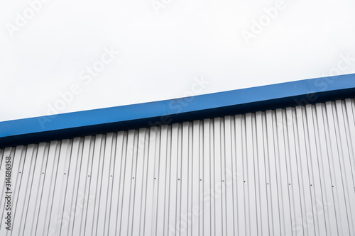 Картината върху платно Metal corrugated sheets on a building with a blue metal corners
