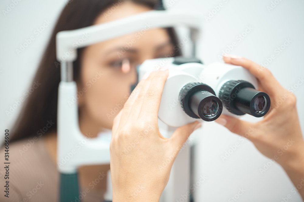 Girl checks eyesight Girl checks eyesight