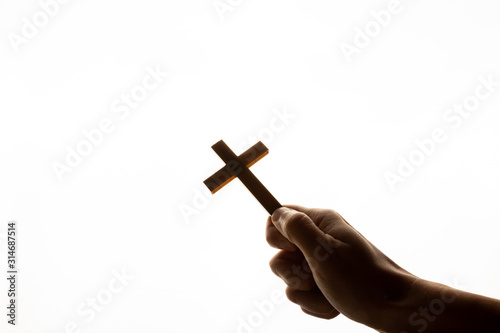 Male hand holding cross on white background