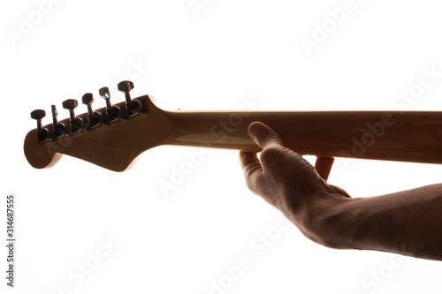 man playing the guitar holding the fretboard