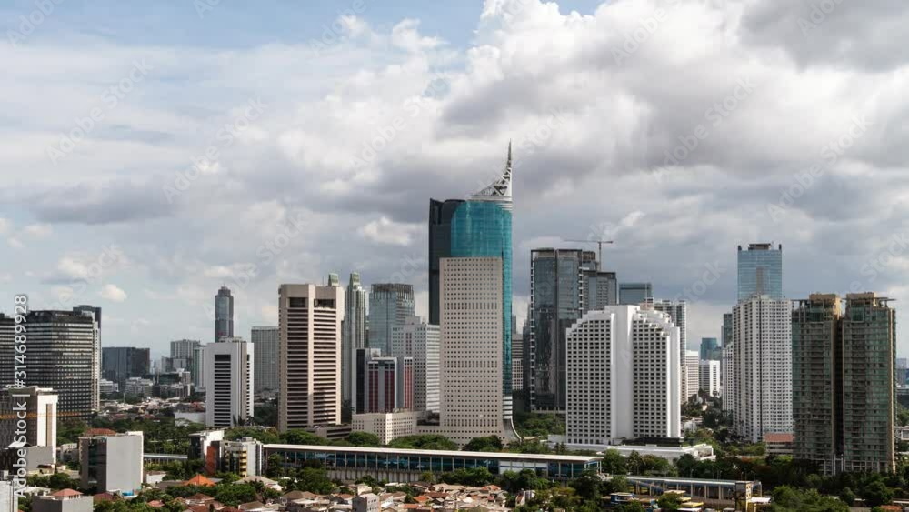 Time lapse of clouds moving fast above the Jakarta business district skyline in Indonesia capital city. Jakarta is a major business and financial center in Southeast Asia and has high growth Time lapse of clouds moving fast above the Jakarta business district skyline in Indonesia capital city. Jakarta is a major business and financial center in Southeast Asia and has high growth