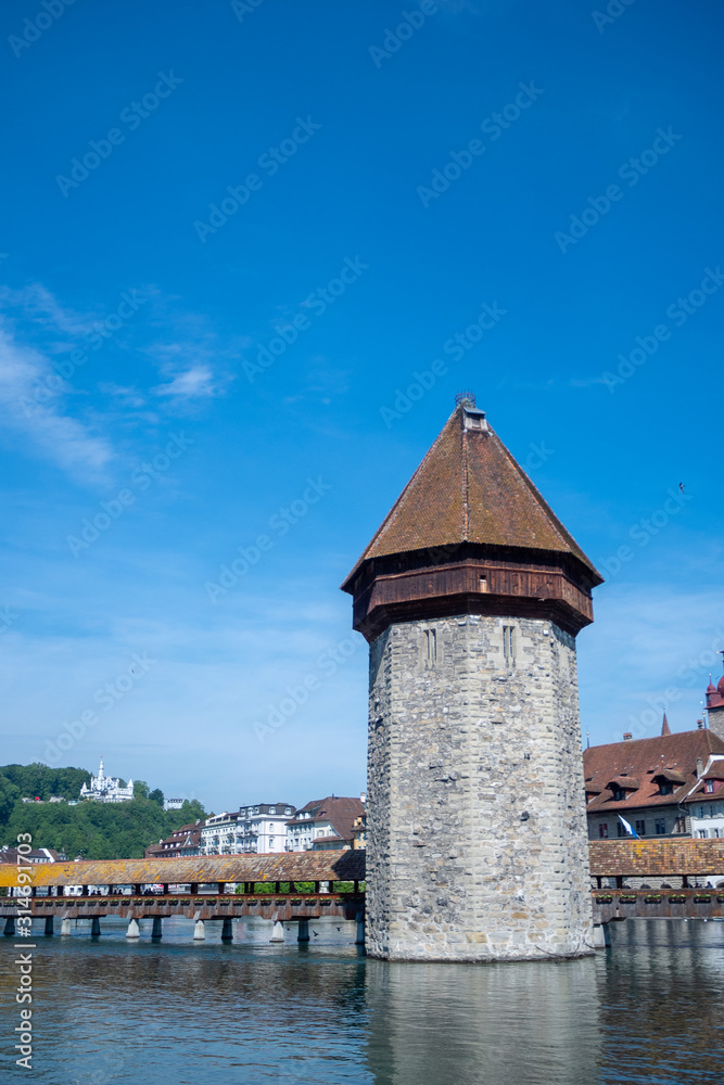 Famous stone tower at Chapel bridge on blue sky for backgrond with copy space, Luzern, Switzerland