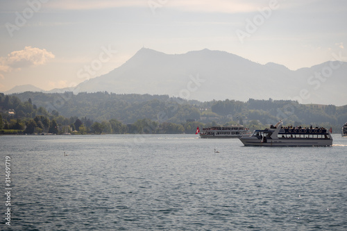 Charming scene of farry boat in Lake Lucerne with mountain and sky background, copy space, Switzerland © Akara