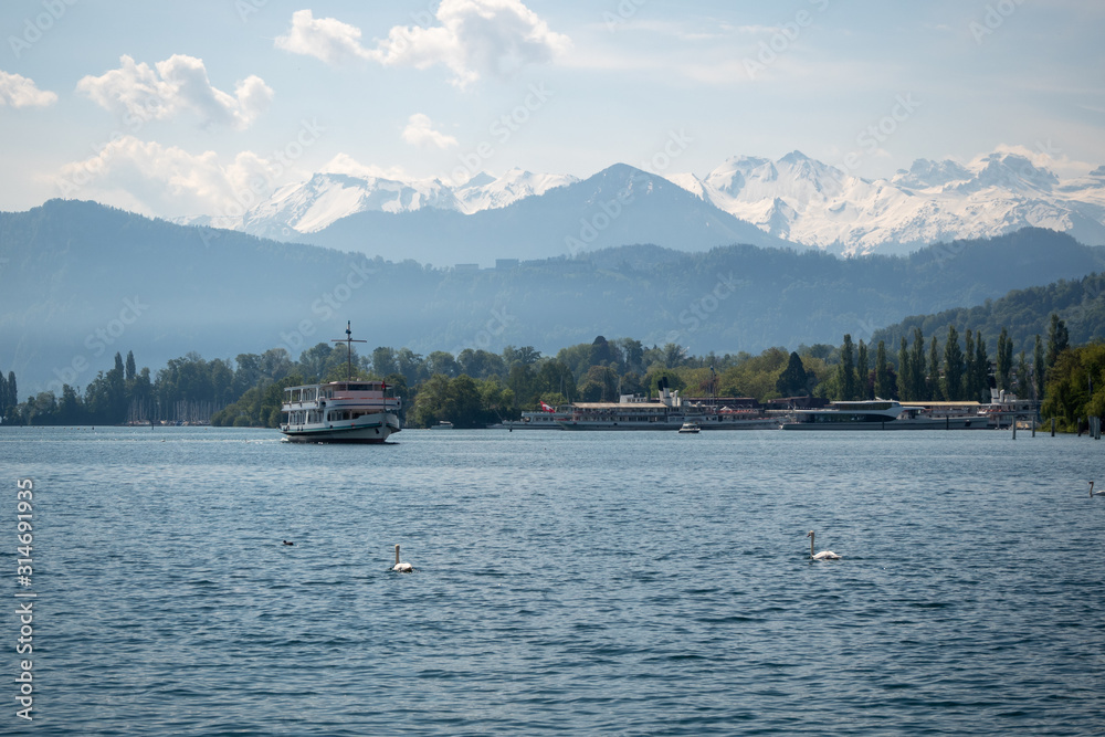 Beautiful scene of Lake Lucerne with farry boat on mountain and sky background, copy space, Switzerland