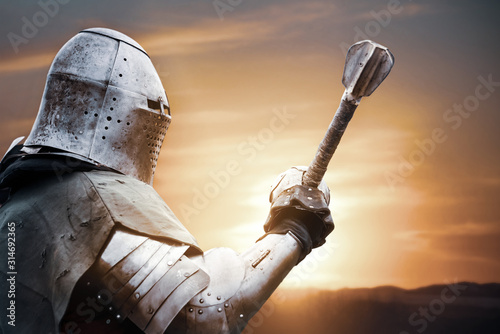 Medieval knight posing with sword.