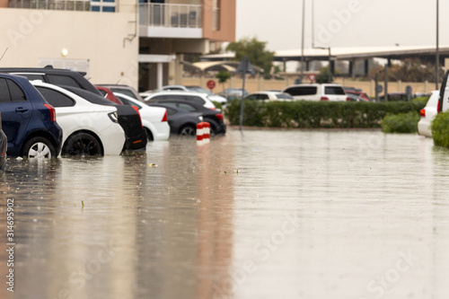 Cars stuck in water in a flooded parking lot after heavy in rain in Dubai