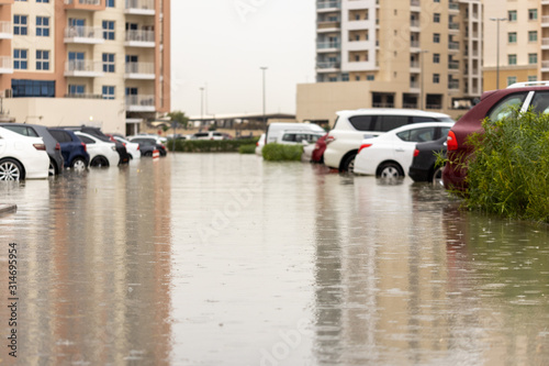 Cars stuck in water in a flooded parking lot after heavy in rain in Dubai