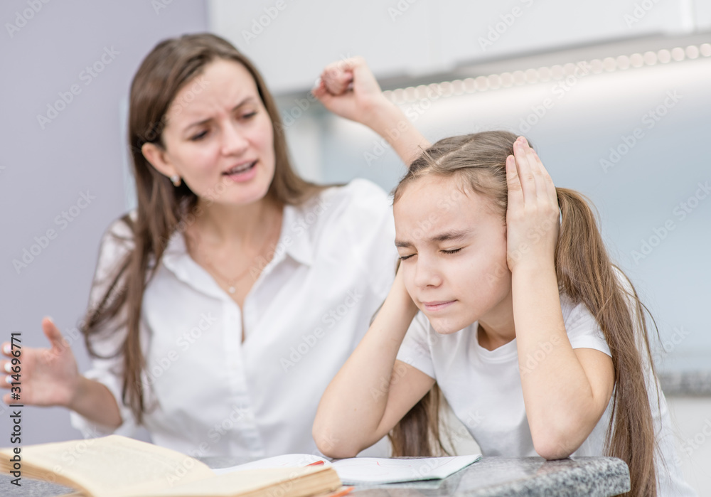 Mother scolds daughter for poor school. girl closed her eyes and ears and ignores mom. Family relationships