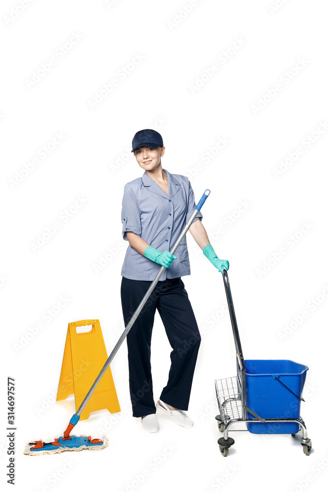 Girl in a cleaning uniform with a mop and a bucket on wheels, isolated on white background