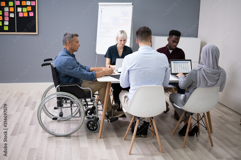 Disabled Businessman In Conference Room Disabled Businessman In Conference Room