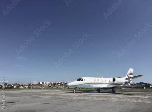 Private jet parked in airport yard preparing for boarding
