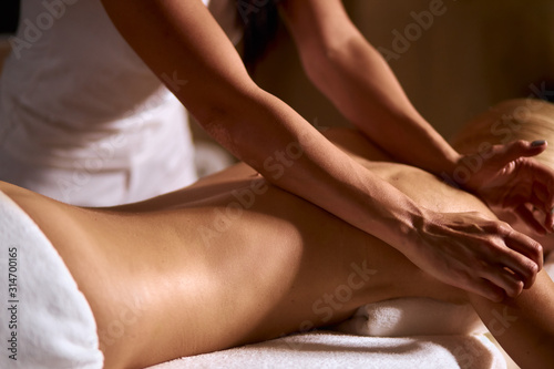 Wallpaper Mural Gentle female hands of professional massage therapist doing back massage in wellness beauty spa, health treatment concept, close up Torontodigital.ca