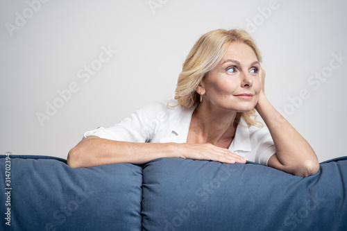 Woman leaning her elbow on the couch