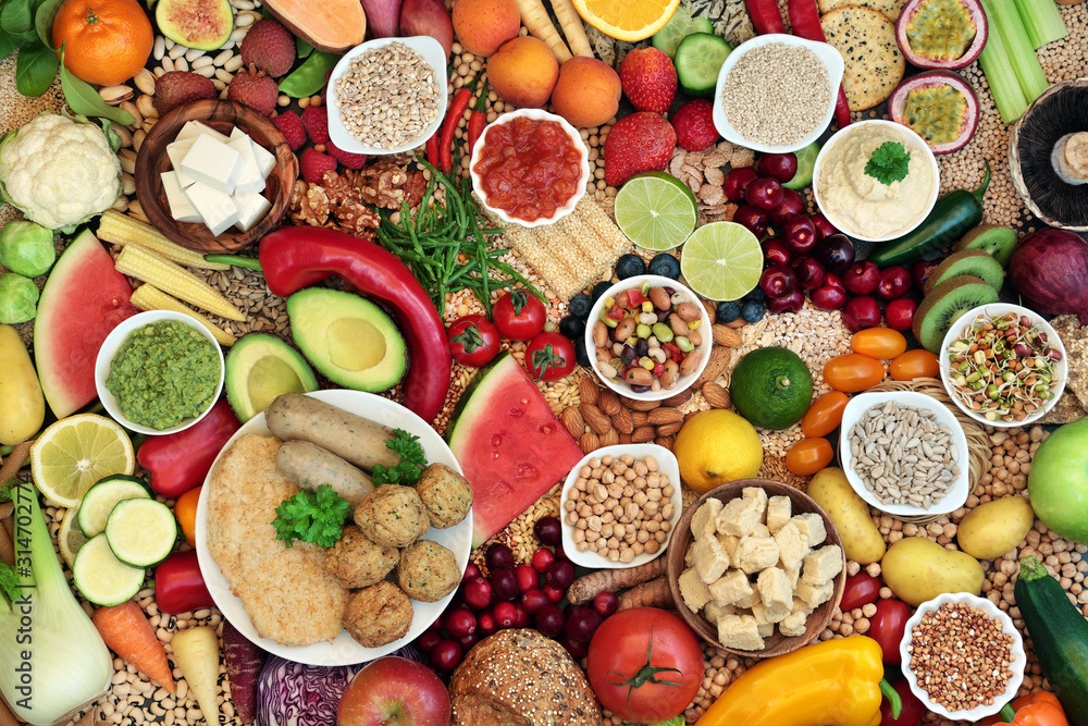 Vegan food for ethical eating concept with foods high in protein, vitamins, minerals, anthocyanins, antioxidants, fibre, omega 3 and smart carbs. Flat lay. Vegan food for ethical eating concept with foods high in protein, vitamins, minerals, anthocyanins, antioxidants, fibre, omega 3 and smart carbs. Flat lay.