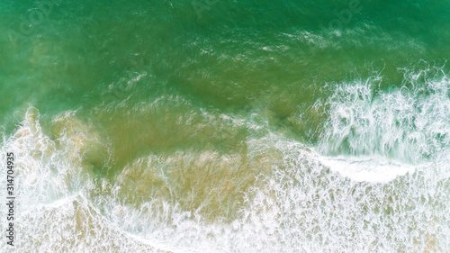 Top view nature landscape of Flowing wave white seafoam turquoise waves Beautiful tropical sea in summer season image by Aerial view drone shot, high angle view Top down. © panya99