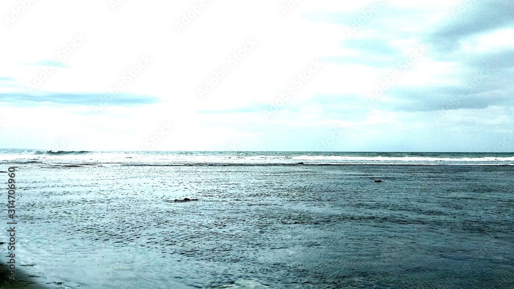 Fototapeta premium beautiful beach scenery, visible black coral in the middle of the sea